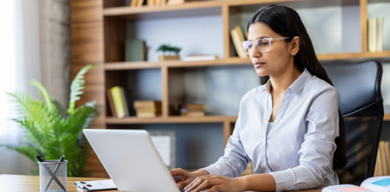 Woman working on a laptop in an office setting